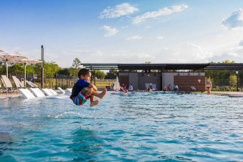 Kid jumping in swimming pool