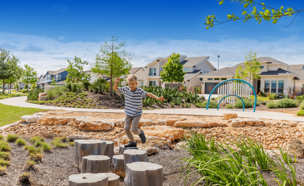 boy jumping from stump to stump
