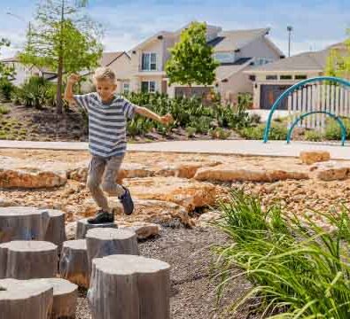Boy jumping from stump to stump
